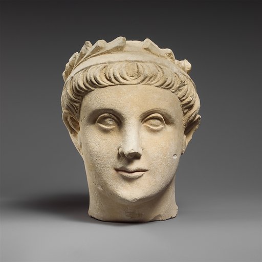 Limestone head of a wreathed youth