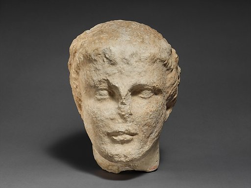 Limestone head of a bearded male votary