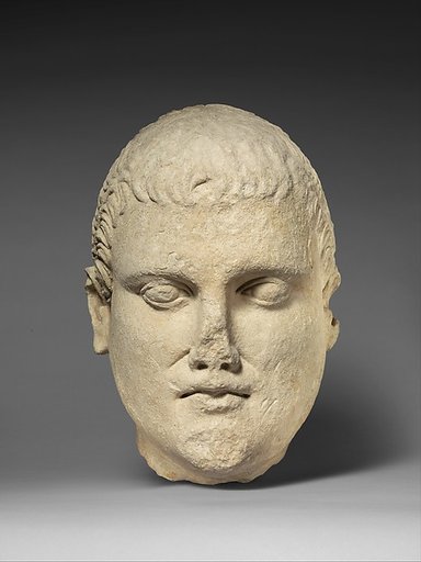 Limestone head of beardless male votary