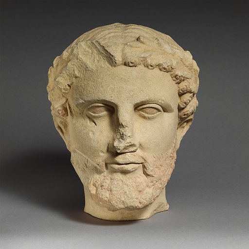 Limestone bearded head with a wreath of leaves