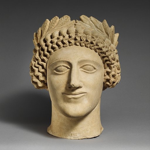 Limestone head of a youth with wreath
