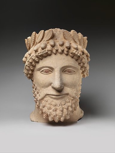 Limestone head of a bearded man wearing a wreath