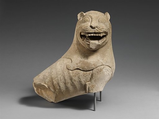 Limestone finial of a funerary stele with a seated lion