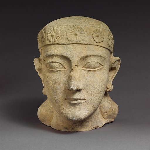 Limestone head of a beardless male with a diadem