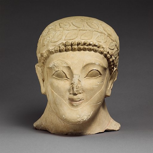 Head of a bearded male with a wreath of leaves