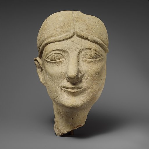 Limestone head of a beardless male with a fillet