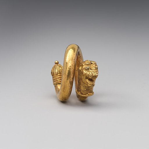 Gold and copper alloy spiral with lion-head terminal
