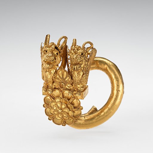 Gold spiral with double lion-griffin-head terminal