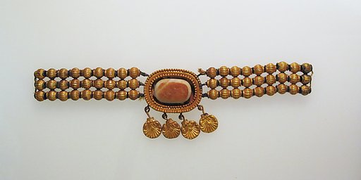 Necklace with gold beads and pendants attached to agate in box setting