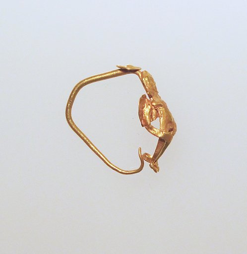 Gold earring with winged figure