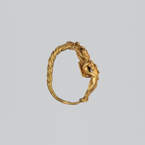 Gold earring with winged figure (one of a pair)