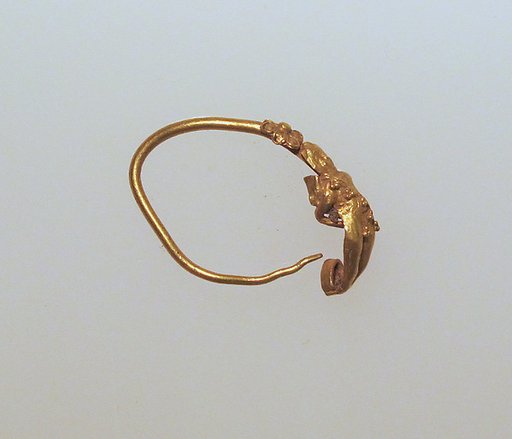 Gold earring with figure