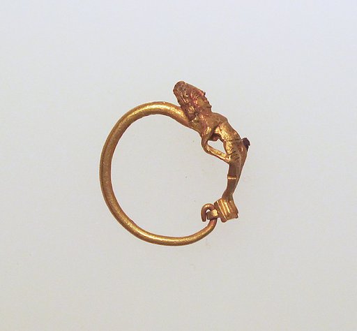 Gold earring with figure