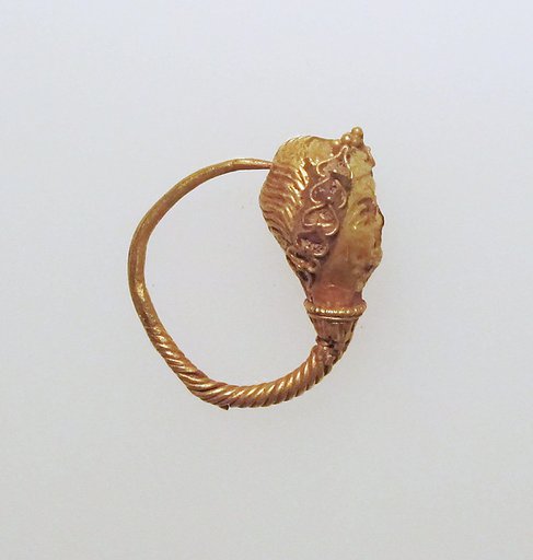 Gold earring with woman's head