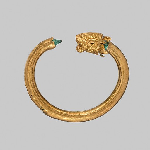 Gold and copper alloy bracelet with lion-head finials