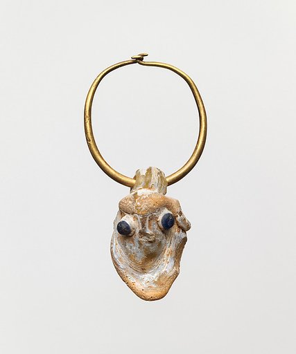 Gold earring with a glass pendant in the form of a demonic mask