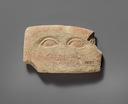 Limestone plaque with two eyes