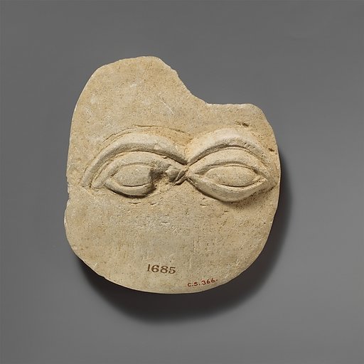 Limestone plaque with two eyes in relief