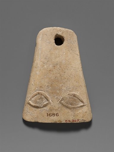 Limestone plaque with two eyes in relief