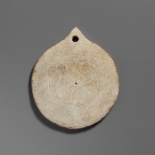 Limestone disk with geometric decoration