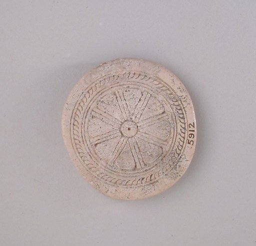 Ivory disk of a pyxis with rosette