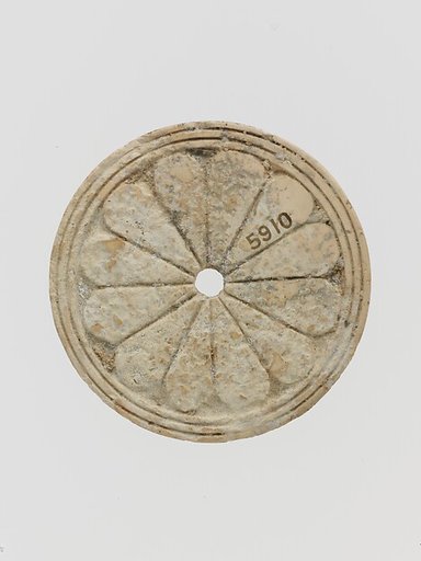 Ivory disk of a pyxis with rosette