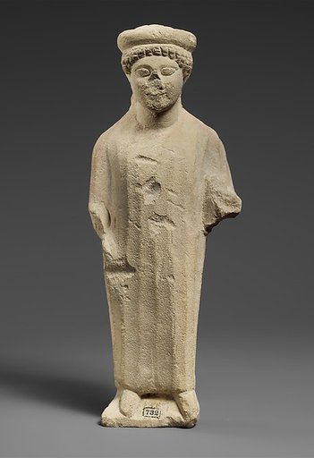 Limestone statuette of a boy with a flat headdress