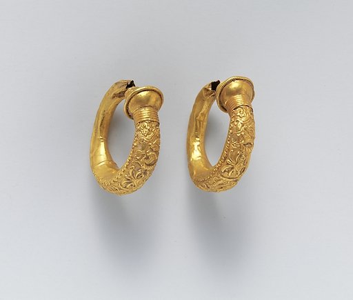 Gold trumpet-shaped earrings with relief decoration