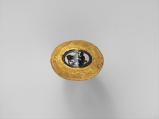 Banded agate intaglio set in a large gold ring