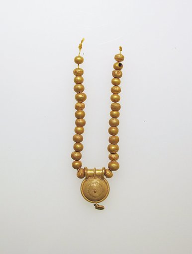 Necklace with bulla and gold beads
