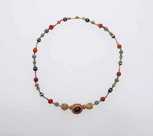 Gold, emerald, carnelian, banded onyx, and garnet necklace