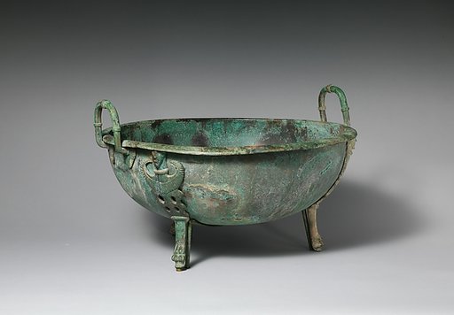 Bronze handled basin with three feet
