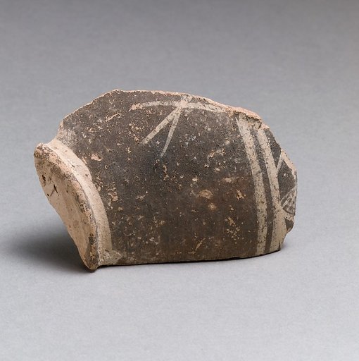 Terracotta base of a small vase with linear decoration