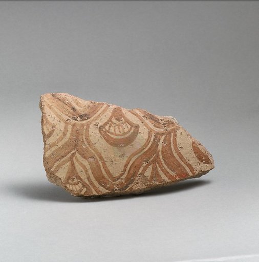 Two terracotta fragments of a large jar with reticulated pattern enclosing conventional flowers