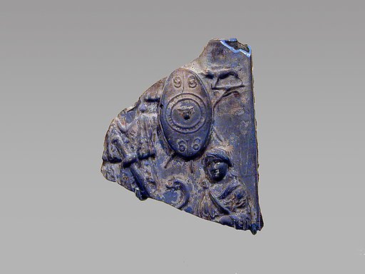 Glass plaque fragment depicting a trophy and captives