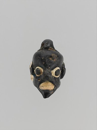Glass pendant in the form of a demonic mask