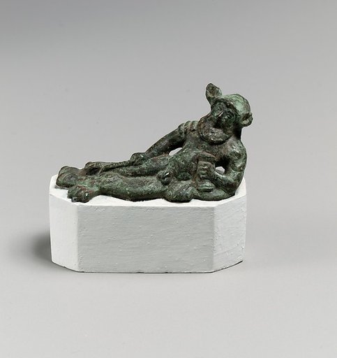 Bronze statuette of a satyr reclining on a lion's skin