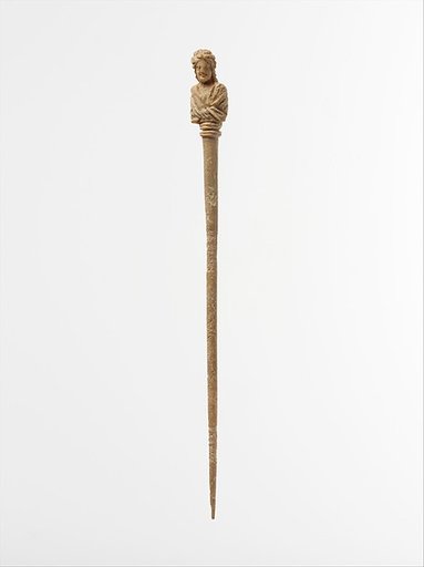 Bone hairpin with bust of a woman