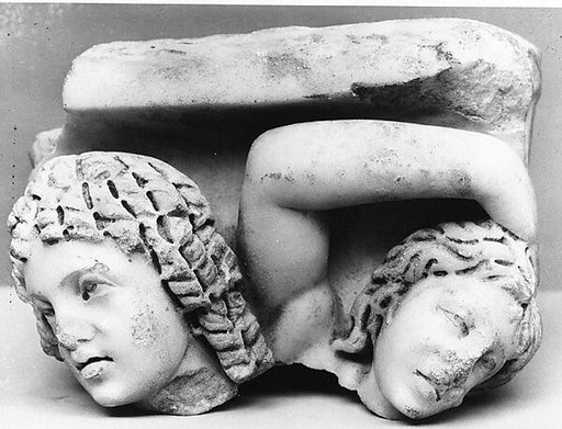Upper right corner of a marble sarcophagus: head of a Black African and a maenad