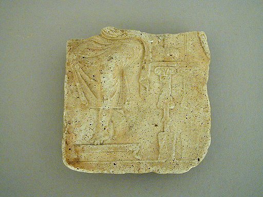 Plaster relief fragment with a male figure on a throne