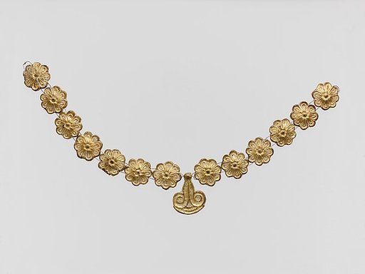 Gilt terracotta ornaments from a necklace