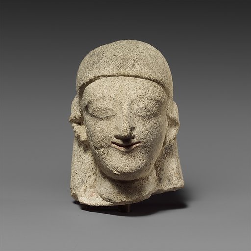 Limestone head of a female with a plain headdress