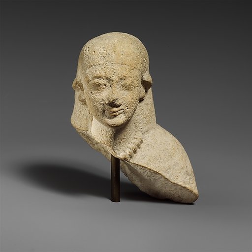 Upper part of a female limestone votary