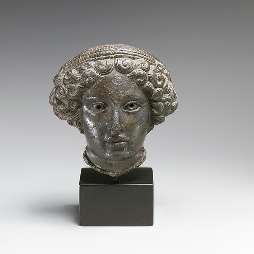 Bronze relief of the head of a woman