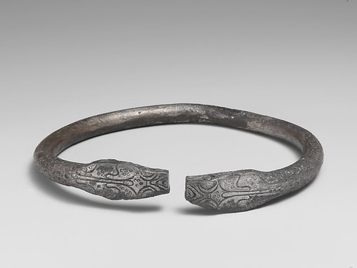 Pair of silver bracelets ending in snake's heads