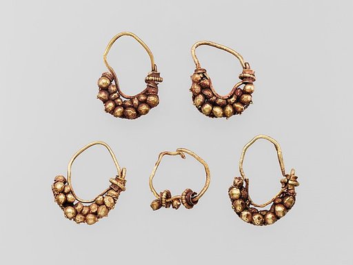 Five gold earrings with spherical elements