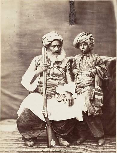 [Turbaned Man Holding Rifle with Boy Alongside]