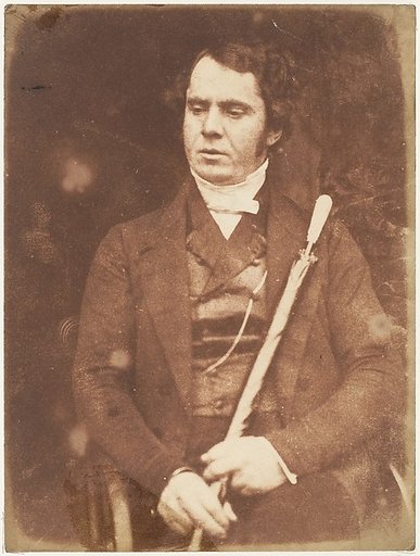 [Man Holding Umbrella]