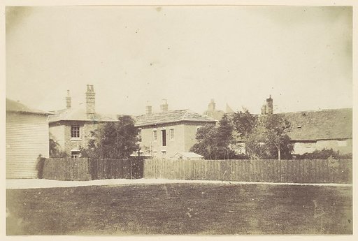 [Compound of Buildings Surrounded by Fence]