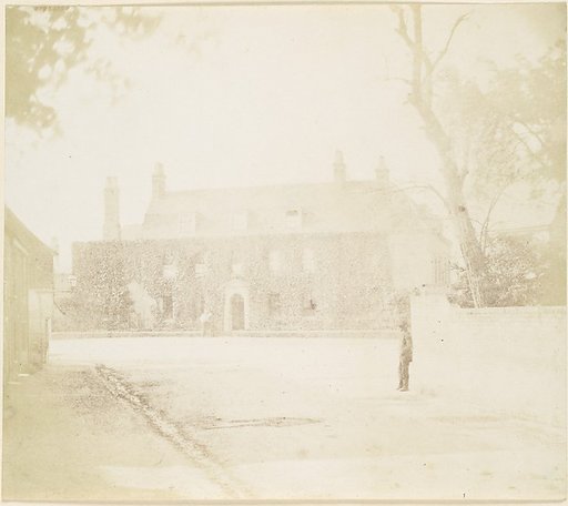 [Man in Courtyard Before House]